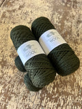 Two balls of Kangaroo Island Wool yarn on a wooden surface