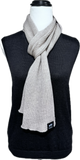 Kangaroo Island Wool Scarf Dune colour (beige) over a charcoal v neck vest.